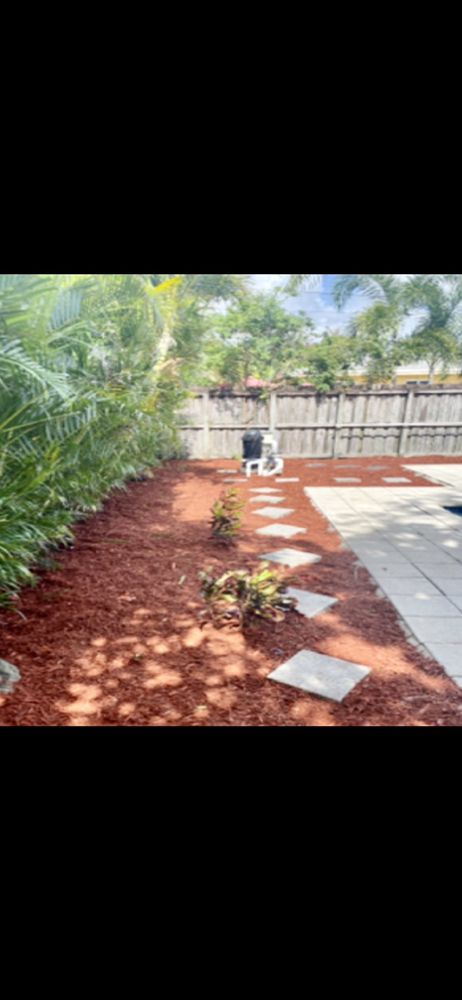 Mulch installation around a pool deck